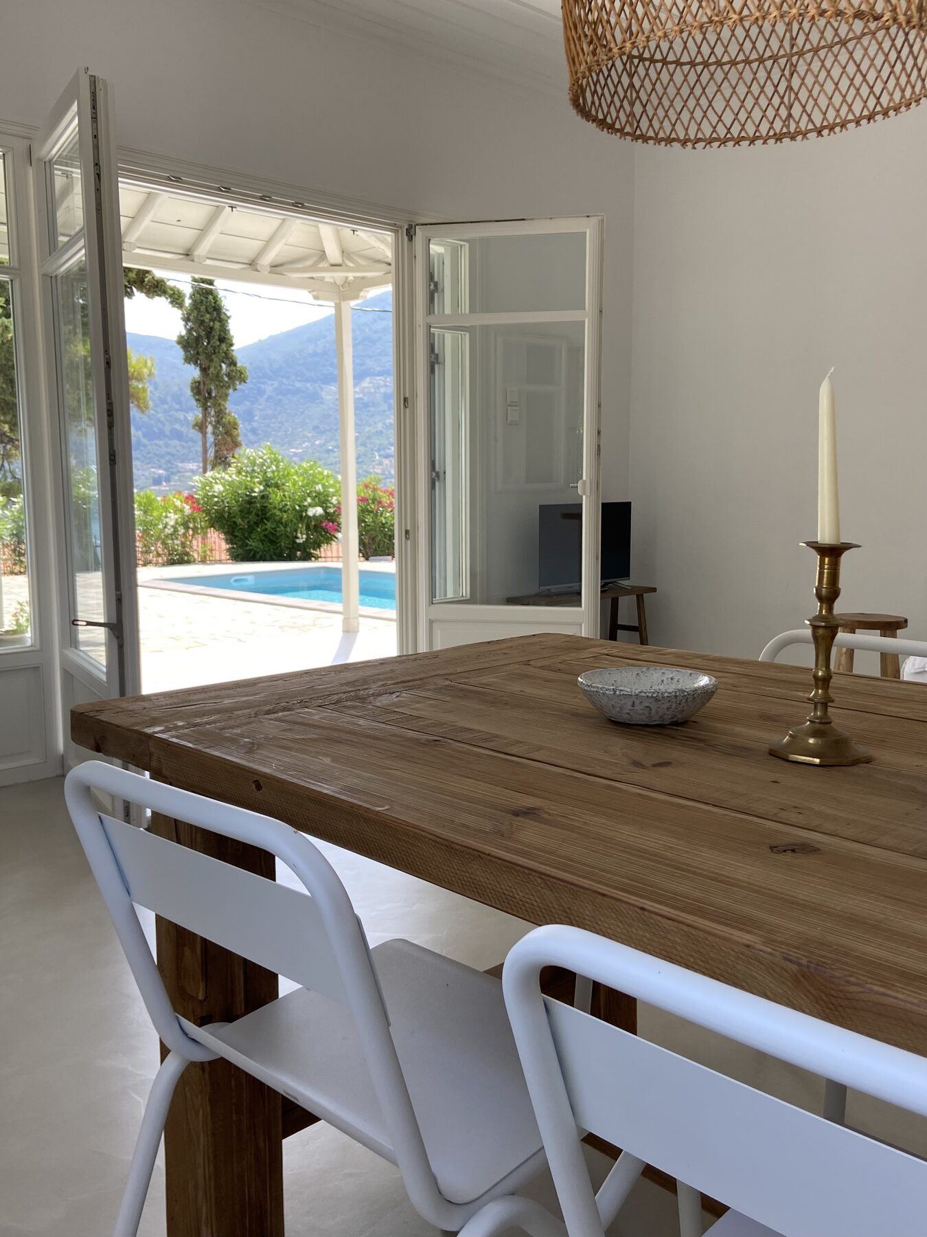 Dining table with doors open onto the pool